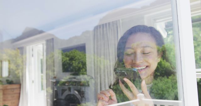 Young Woman Smiling While Using Smartphone at Home - Download Free Stock Images Pikwizard.com