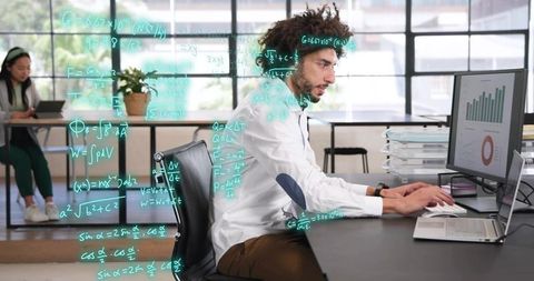 Male data analyst typing at open-plan desk with dashboard charts and floating equations