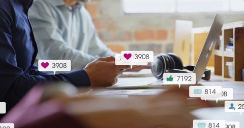 Team Reviewing Social Media Notifications in Modern Office