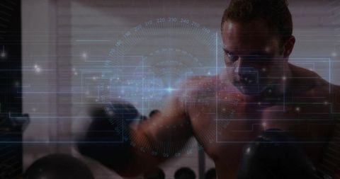 Shirtless boxer throwing punch with futuristic augmented reality hud overlay in gym