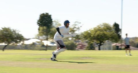 Cricket batsman running for single after drive on grass pitch showing action and speed