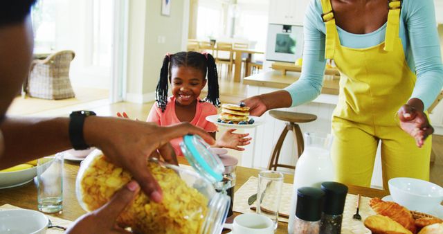 Family Enjoying Breakfast Together with Pancakes and Cereals - Download Free Stock Images Pikwizard.com