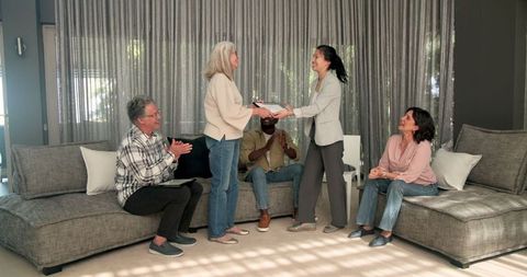 Therapist presenting awards in group therapy session