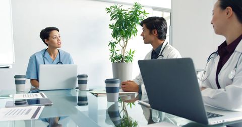 Medical Professionals Collaborating in Modern Office Meeting