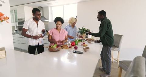 Friends Collaborating in Modern Kitchen for Group Meal