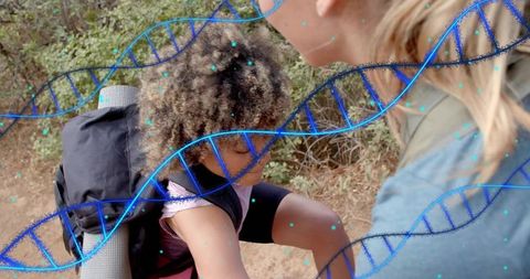 Adult steadying child on hiking trail with backpack and dna double-exposure overlay
