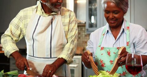 Senior Couple Engaging in Cooking Meal Together at Home