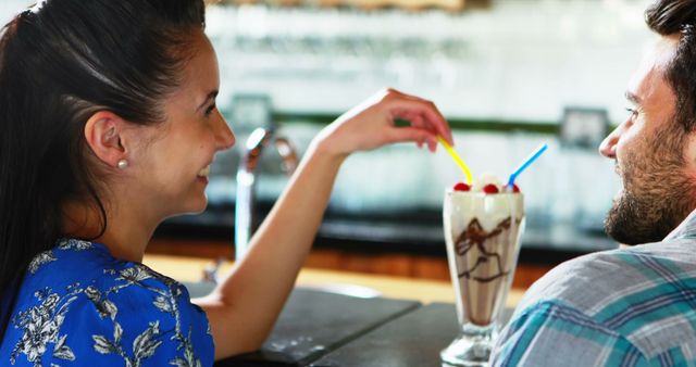 Happy Couple Sharing Milkshake in Cozy Café - Download Free Stock Images Pikwizard.com