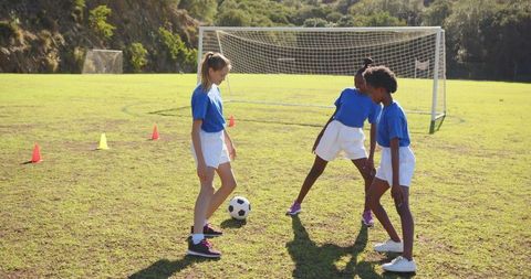 School Girls Practicing Soccer on Sunny Field