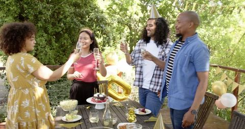 Diverse Friends Toasting at Joyful Birthday Terrace Party