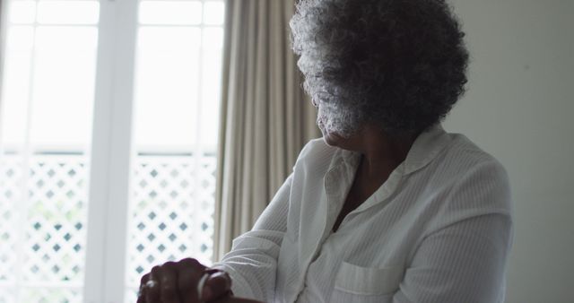 Senior Woman Relaxing Indoors Near Window - Download Free Stock Images Pikwizard.com