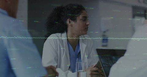 Healthcare professionals analyzing digital patient data in hospital setting