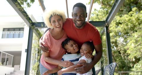 Happy multicultural family spending quality time outdoors on sunny day