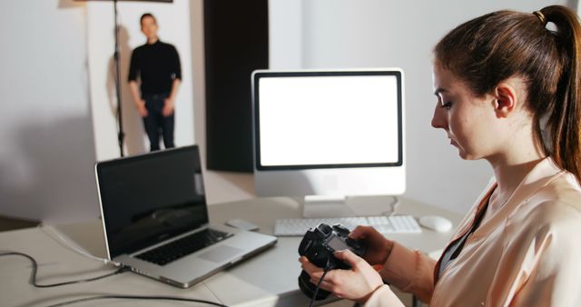 Female Photographer Reviewing Photos in Studio with Digital Camera - Download Free Stock Images Pikwizard.com