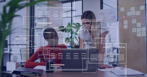 Women Collaborating Over Laptop Analyzing Data Overlays for Team Analytics and Strategy