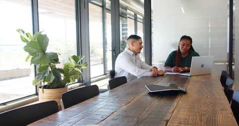 Colleagues Discussing Business Plan in Modern Office Meeting Room