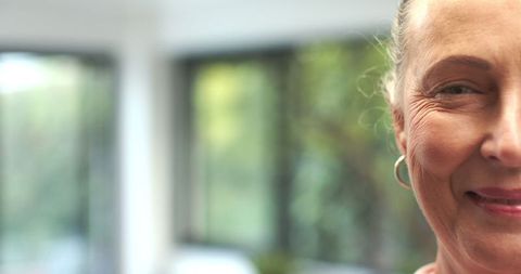 Smiling Senior Woman in Bright Modern Interior Closeup