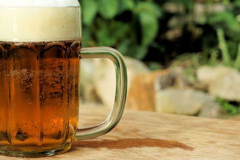 Close-Up of Beer Mug with Frothy Head Outdoors