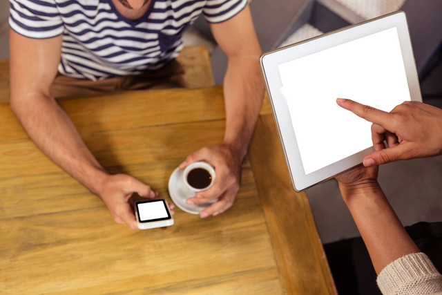 Transparent Screen Interaction with Tablet and Phone at Cafe - Download Free Stock Videos Pikwizard.com