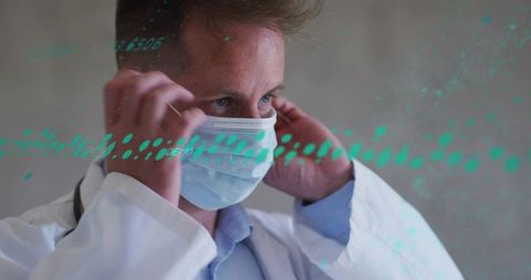 Male doctor adjusting surgical mask with teal digital overlay, stethoscope portrait