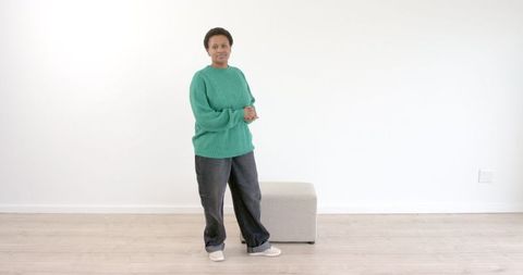 Woman in Green Sweater Contemplatively Standing Indoors - Download Free Stock Images Pikwizard.com