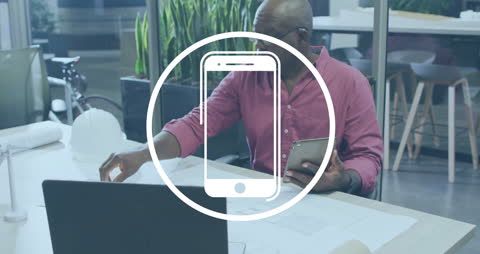 African American Architect with Smartphone and Laptop in Office