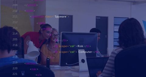 Smiling blonde woman collaborating at central monitor with code overlay in modern office
