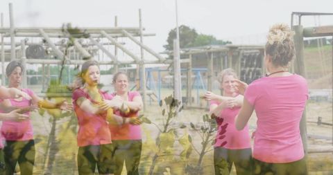 Women Stretching on Obstacle Course Promoting Team Fitness