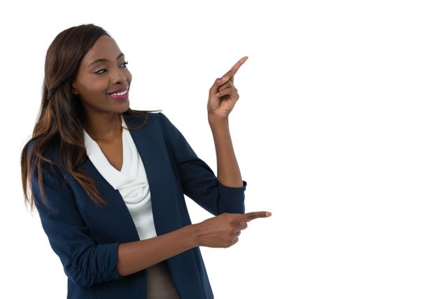 Smiling businesswoman gesturing during presentation against white background
