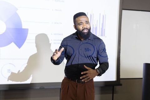 Business Professional Compellingly Presents Data in Corporate Meeting