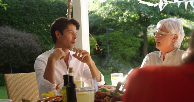 Family Members Conversing During Outdoor Lunch - Download Free Stock Images Pikwizard.com