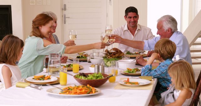 Happy Family Gathering Around Dining Table to Celebrate Special Occasion - Download Free Stock Images Pikwizard.com