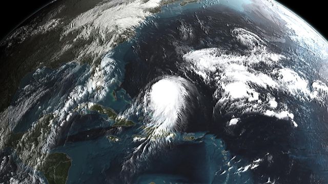 NASA's satellite image of Hurricane Joaquin shows the storm forming over the Atlantic Ocean between the Bahamas and Bermuda. Useful for weather forecasting, natural disaster analysis, and educational purposes related to meteorology and Earth sciences.