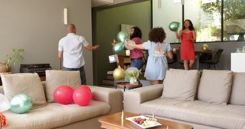 Diverse Friends Decorating for Festive Housewarming Party