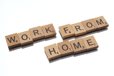Wooden tiles spelling work from home on white background