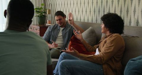 Friends enjoying cozy conversation on comfortable sofa