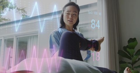 Elderly Woman Exercising with Nurse and Cardiograph Overlay