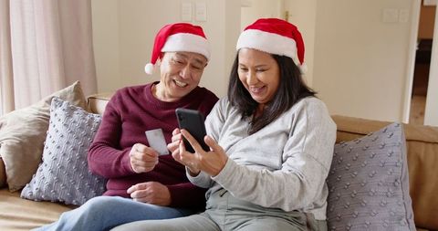 Senior couple shopping online with credit card for christmas