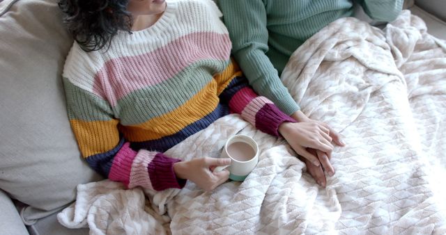 Couple Relaxing on Couch, Holding Hands with Coffee Mug - Download Free Stock Images Pikwizard.com