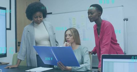 Female Team Reviewing Documents in Modern Office, Collaborating on Business Strategy