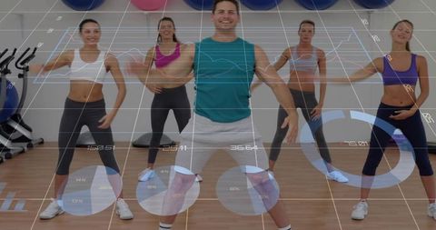 Group fitness instructor leading energetic studio workout with digital performance overlay