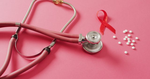 Stethoscope and red ribbon symbol for HIV/AIDS awareness on pink background representing healthcare and disease prevention. Ideal for use in health campaigns, educational materials, medical articles, and awareness event promotions.
