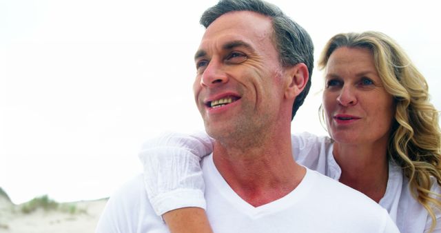 Smiling Mature Couple Enjoying Beach Time Together - Download Free Stock Images Pikwizard.com