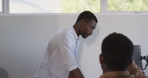 Focused African American Man Multitasking in Office