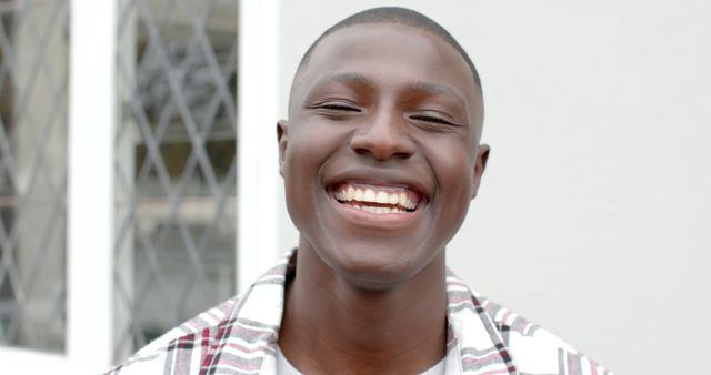 Happy african american man face close up smiling at camera. Masculinity, expression and domestic life, unaltered.