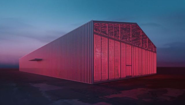 Modern industrial building glowing in red at dusk