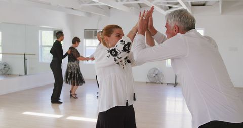 Senior Couples Learning Ballroom Dancing with Instructor