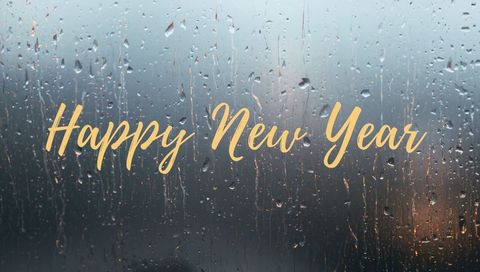 Golden Happy New Year Script on Rain-Streaked Glass with City Bokeh Night Lights