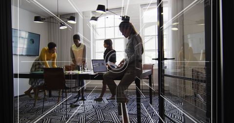 Dynamic business meeting in modern office with technology display