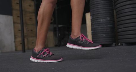 Active Woman Jumping on Gym Mat with Stylish Sneakers